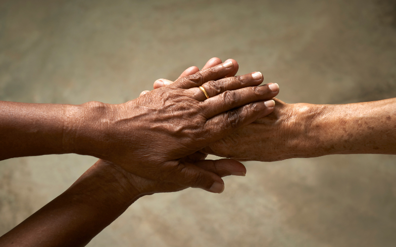 Hands grasping another hand